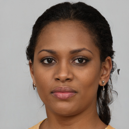 Joyful black young-adult female with medium  brown hair and brown eyes