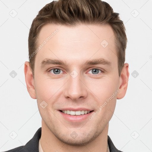 Joyful white young-adult male with short  brown hair and grey eyes