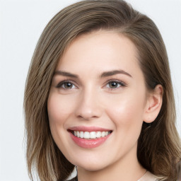 Joyful white young-adult female with long  brown hair and blue eyes