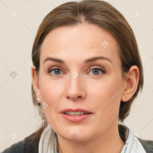 Joyful white adult female with medium  brown hair and grey eyes