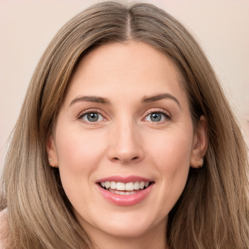 Joyful white young-adult female with long  brown hair and grey eyes