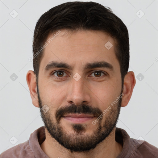 Joyful white young-adult male with short  brown hair and brown eyes