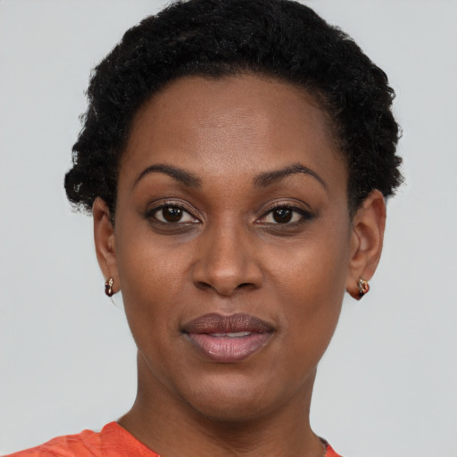 Joyful black young-adult female with short  brown hair and brown eyes