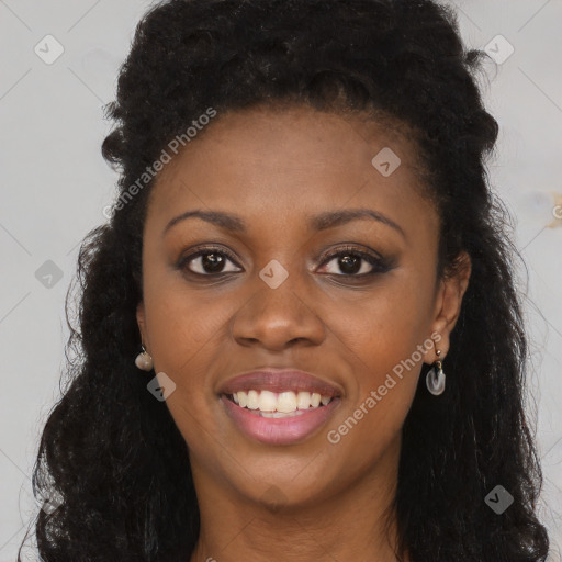 Joyful black young-adult female with long  brown hair and brown eyes