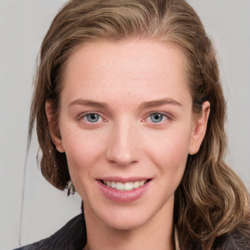 Joyful white young-adult female with medium  brown hair and blue eyes