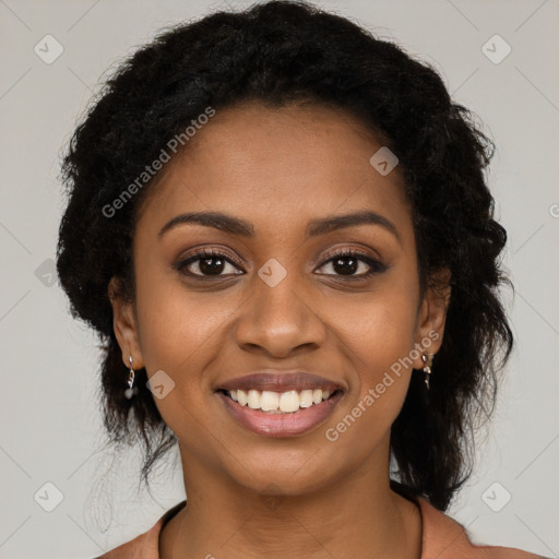 Joyful black young-adult female with long  brown hair and brown eyes