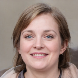 Joyful white young-adult female with medium  brown hair and blue eyes