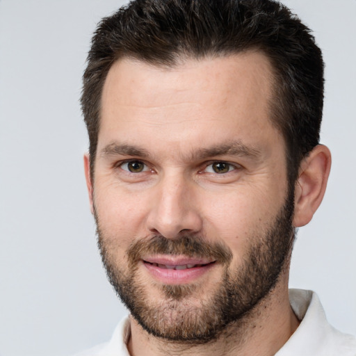 Joyful white adult male with short  brown hair and brown eyes