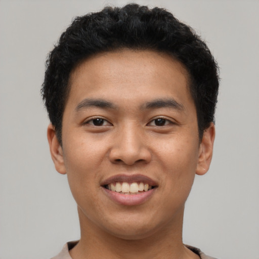 Joyful asian young-adult male with short  black hair and brown eyes