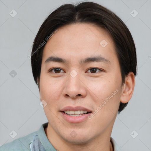 Joyful asian young-adult male with short  brown hair and brown eyes