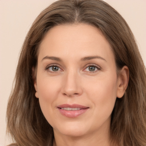 Joyful white adult female with long  brown hair and brown eyes