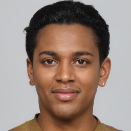 Joyful black young-adult male with short  black hair and brown eyes