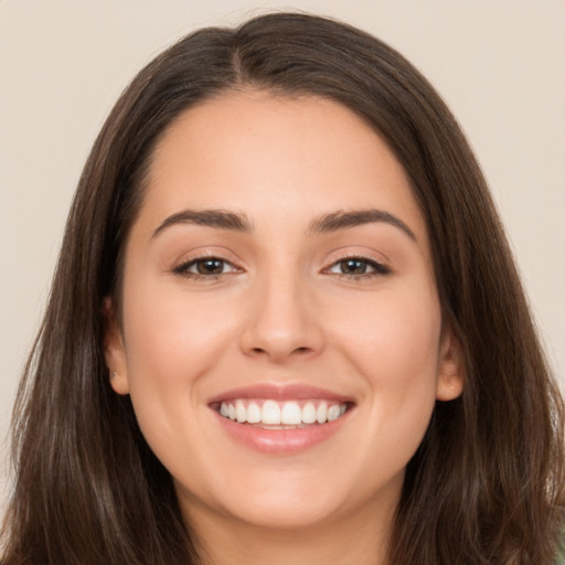 Joyful white young-adult female with long  brown hair and brown eyes