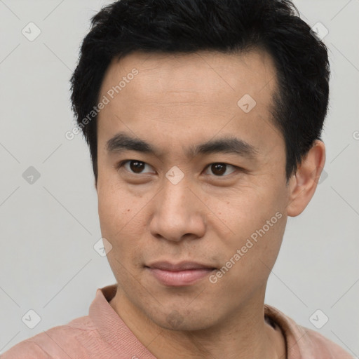 Joyful asian young-adult male with short  brown hair and brown eyes