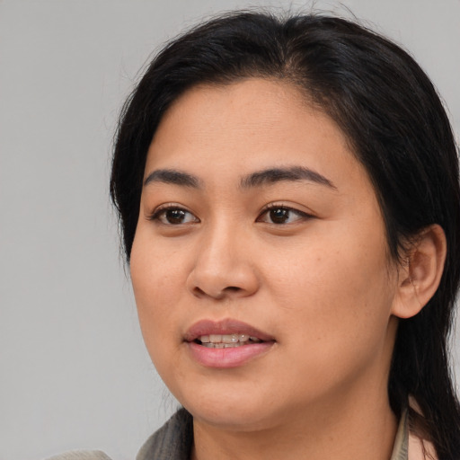 Joyful asian young-adult female with medium  black hair and brown eyes
