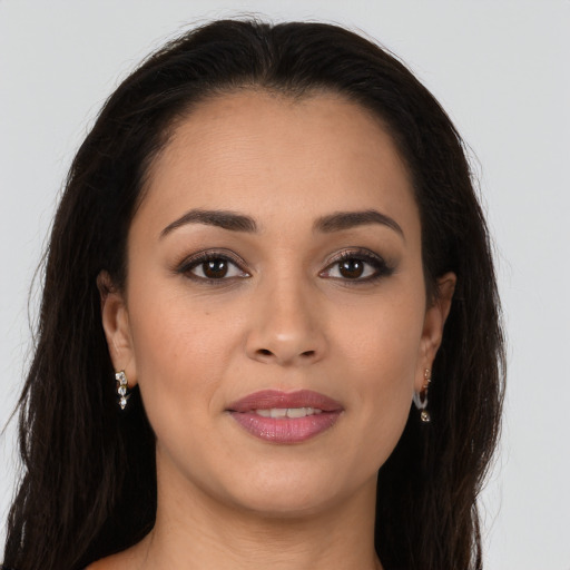 Joyful white young-adult female with long  brown hair and brown eyes