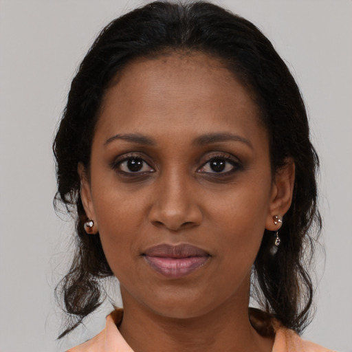 Joyful black young-adult female with medium  brown hair and brown eyes