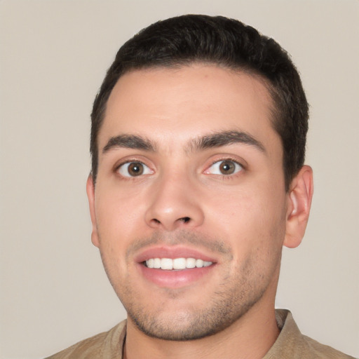 Joyful white young-adult male with short  black hair and brown eyes