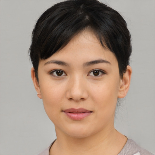Joyful asian young-adult female with short  brown hair and brown eyes