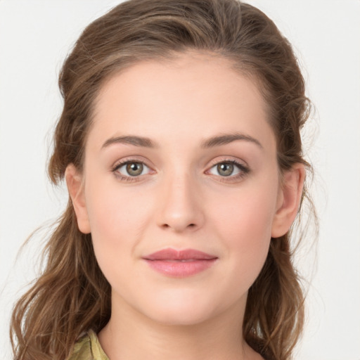 Joyful white young-adult female with long  brown hair and green eyes