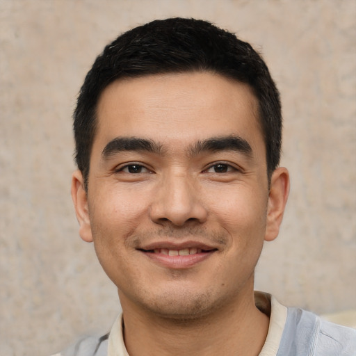 Joyful white young-adult male with short  black hair and brown eyes