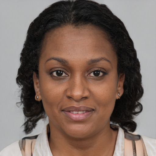 Joyful black young-adult female with medium  brown hair and brown eyes