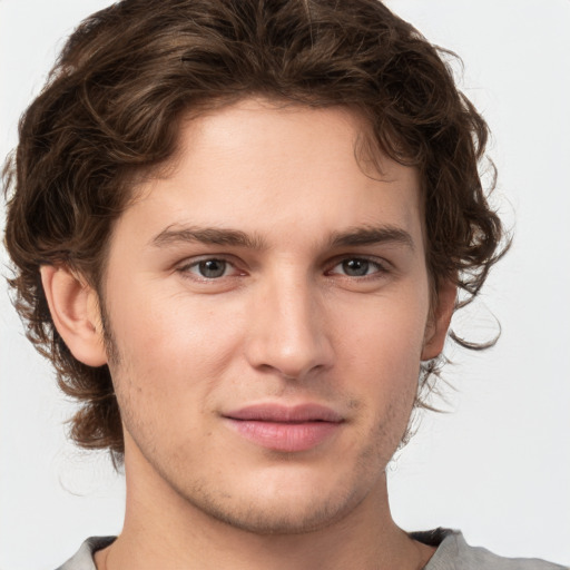 Joyful white young-adult male with medium  brown hair and brown eyes