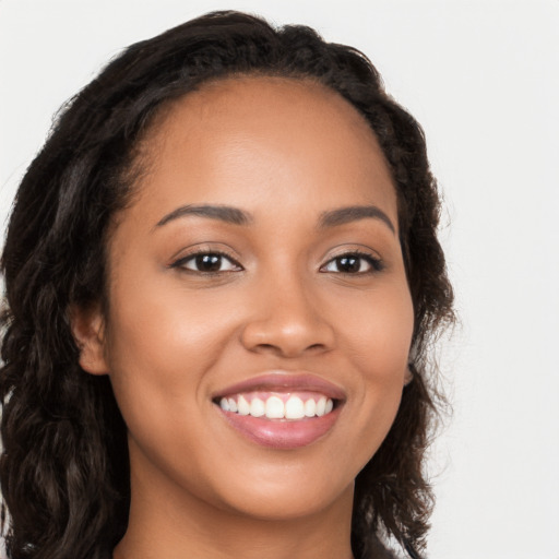 Joyful latino young-adult female with long  brown hair and brown eyes