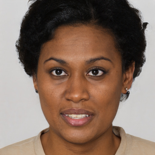 Joyful black young-adult female with short  brown hair and brown eyes