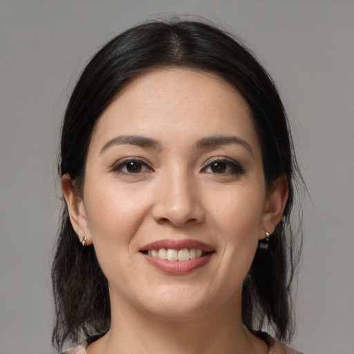 Joyful white young-adult female with medium  black hair and brown eyes