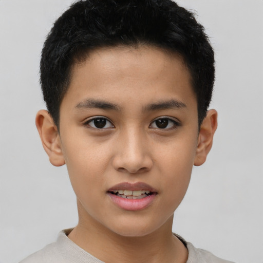 Joyful latino child male with short  brown hair and brown eyes