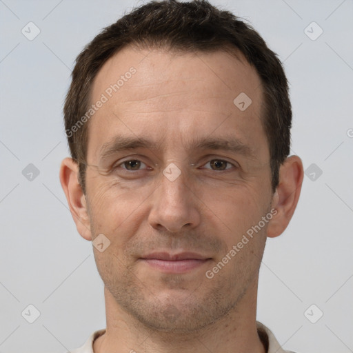 Joyful white adult male with short  brown hair and brown eyes