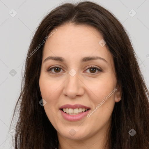 Joyful white adult female with long  brown hair and brown eyes