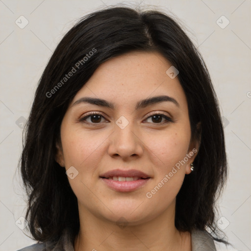 Joyful latino young-adult female with medium  brown hair and brown eyes