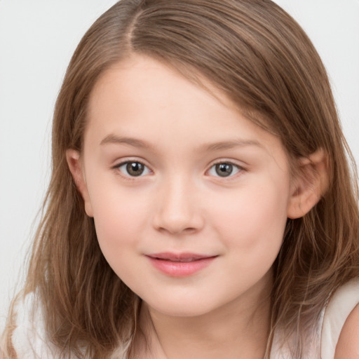 Joyful white child female with long  brown hair and brown eyes