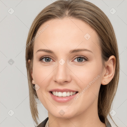 Joyful white young-adult female with medium  brown hair and grey eyes