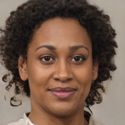 Joyful black adult female with medium  brown hair and brown eyes