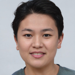 Joyful asian young-adult female with short  brown hair and brown eyes