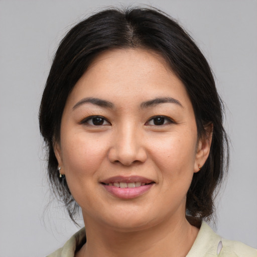 Joyful asian young-adult female with medium  brown hair and brown eyes
