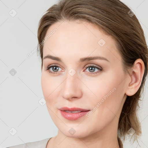 Joyful white young-adult female with long  brown hair and blue eyes