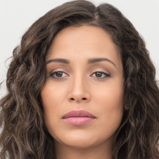 Joyful white young-adult female with long  brown hair and brown eyes