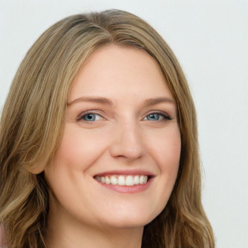 Joyful white young-adult female with long  brown hair and green eyes