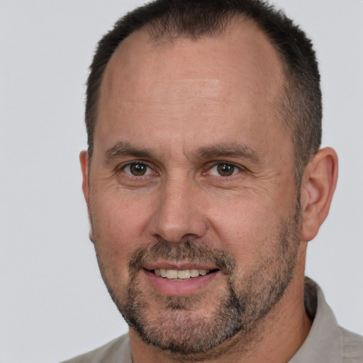 Joyful white adult male with short  brown hair and brown eyes