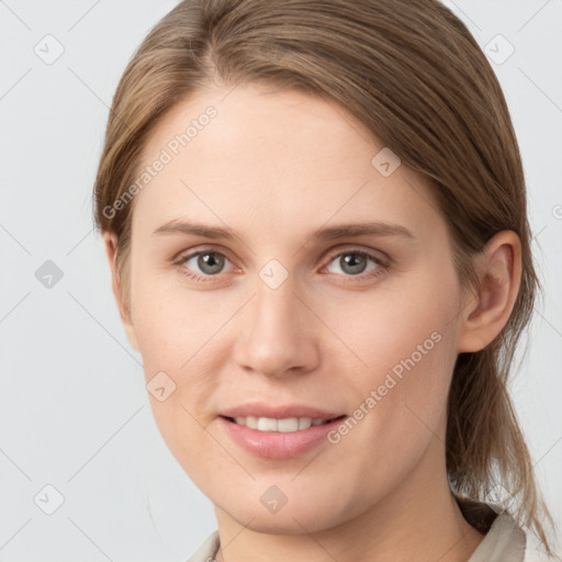 Joyful white young-adult female with medium  brown hair and grey eyes