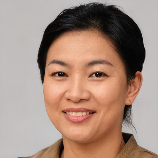 Joyful asian young-adult female with medium  brown hair and brown eyes