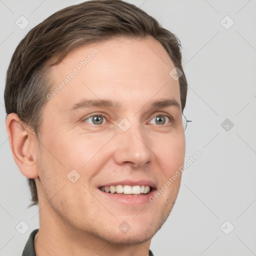 Joyful white young-adult male with short  brown hair and grey eyes