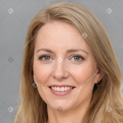 Joyful white adult female with long  brown hair and brown eyes