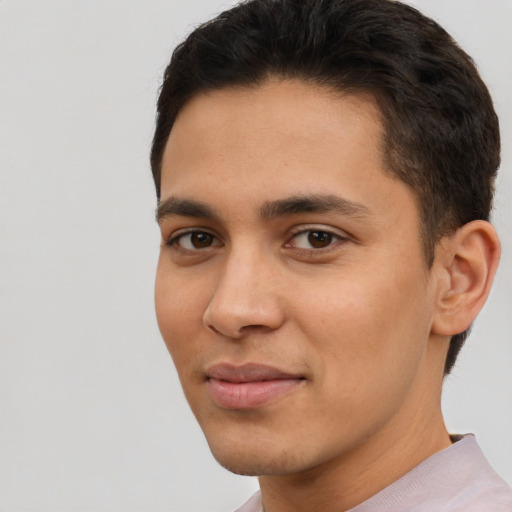 Joyful latino young-adult male with short  brown hair and brown eyes