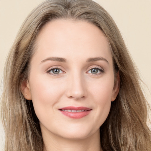 Joyful white young-adult female with long  brown hair and grey eyes