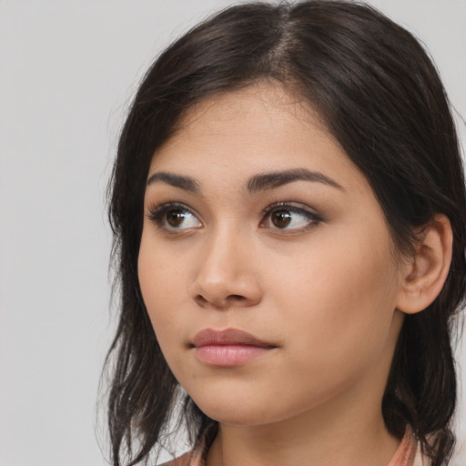 Neutral latino young-adult female with long  brown hair and brown eyes